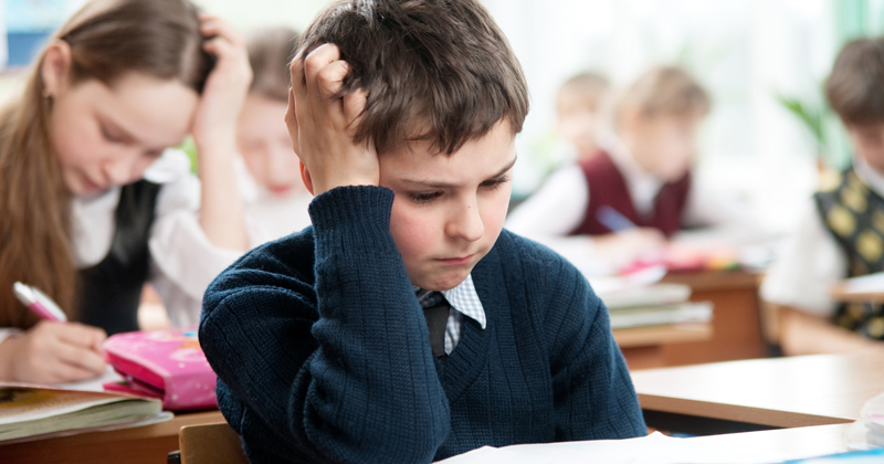 frustrated young child in classroom