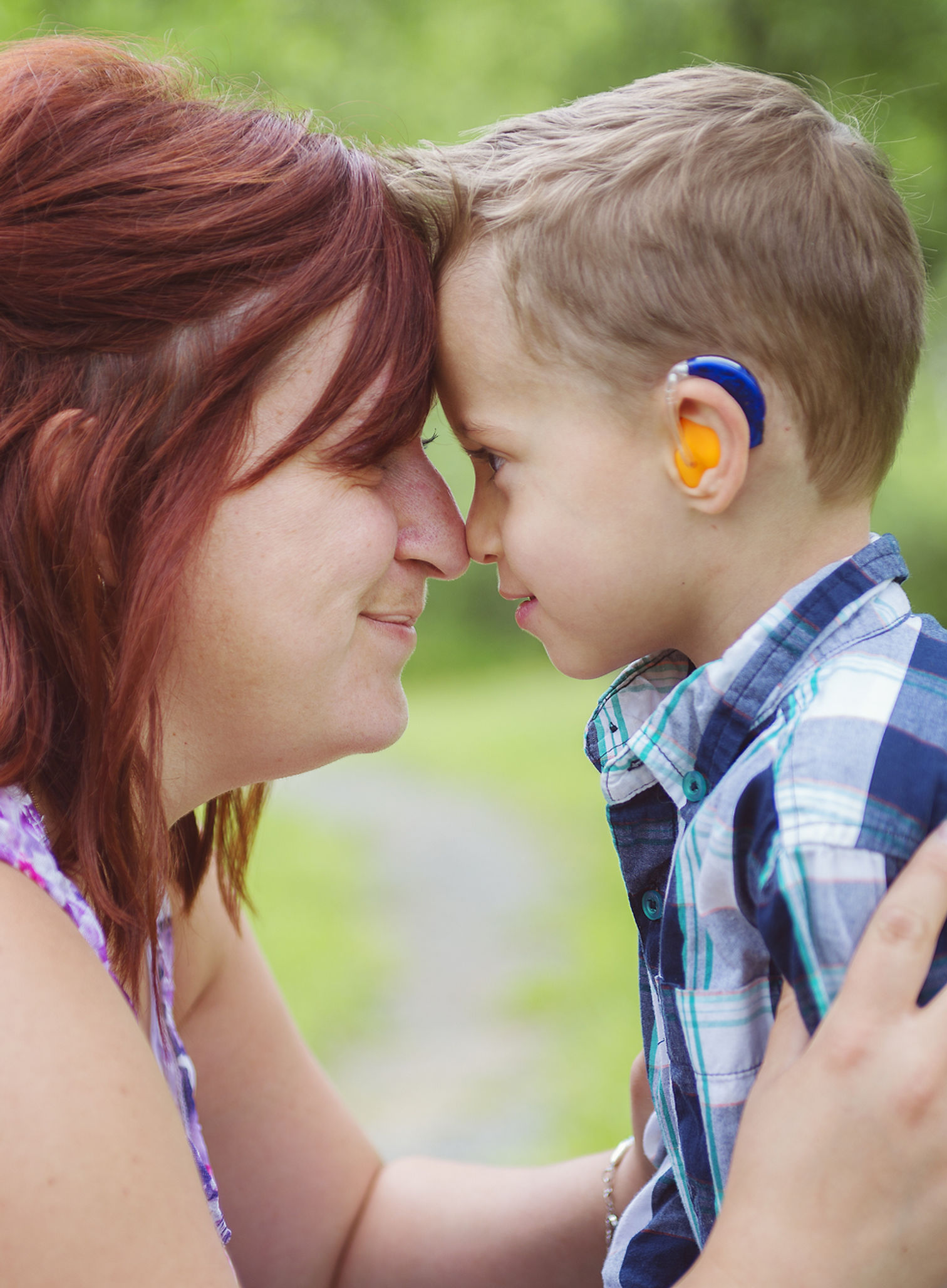 mother and son with hearing aid