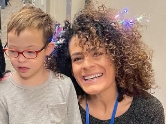 woman smiling next to child